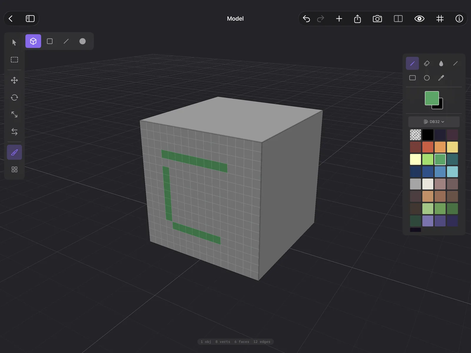 Qwartz on iPad: the Paint tool is on in the tool strip on the left, the paint palette is open on the right, and a cube shows green pixels painted on one face, over that face's pixel grid.